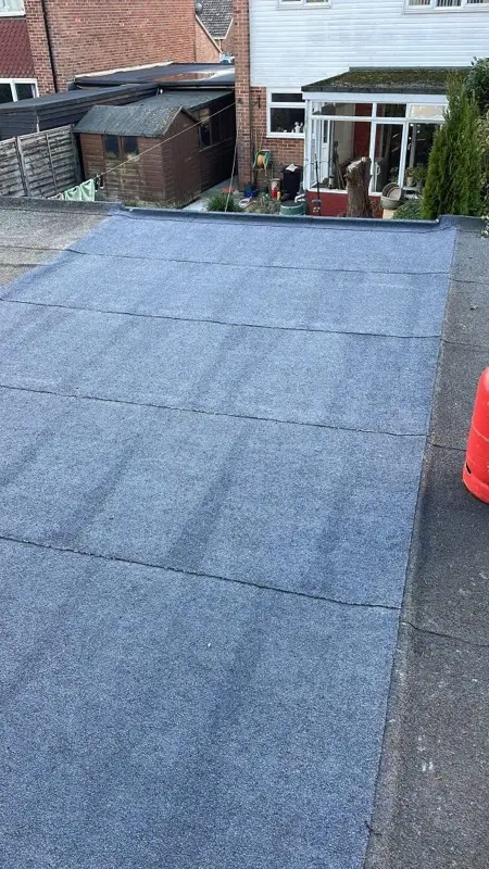 Completed mineral felt flat roof over a rear extension with clean drainage falls