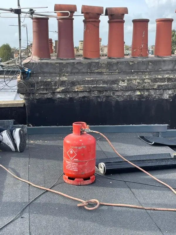 Flat roof edge trim and lead capping fitted to a parapet wall