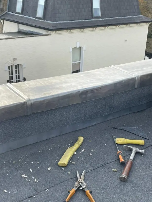 New lead parapet capping and felt upstand forming a watertight flat roof edge